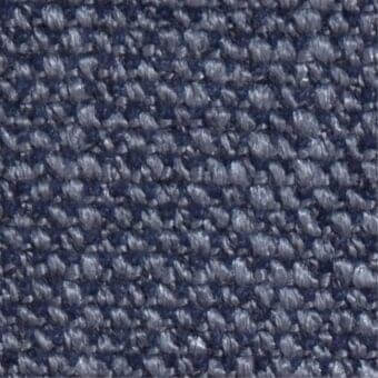 Indigo fabric texture displaying a dense, looped weave with a granular surface and matte finish, exhibiting consistent coloration.